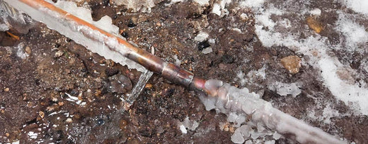 Burst frozen pipe leaking water during freezing temperatures in Austin, highlighting the importance of pipe insulation and repair