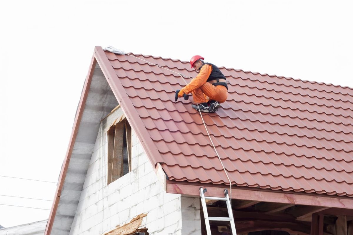 Worker Repairing Residential Metal Roof - AllDone Construction