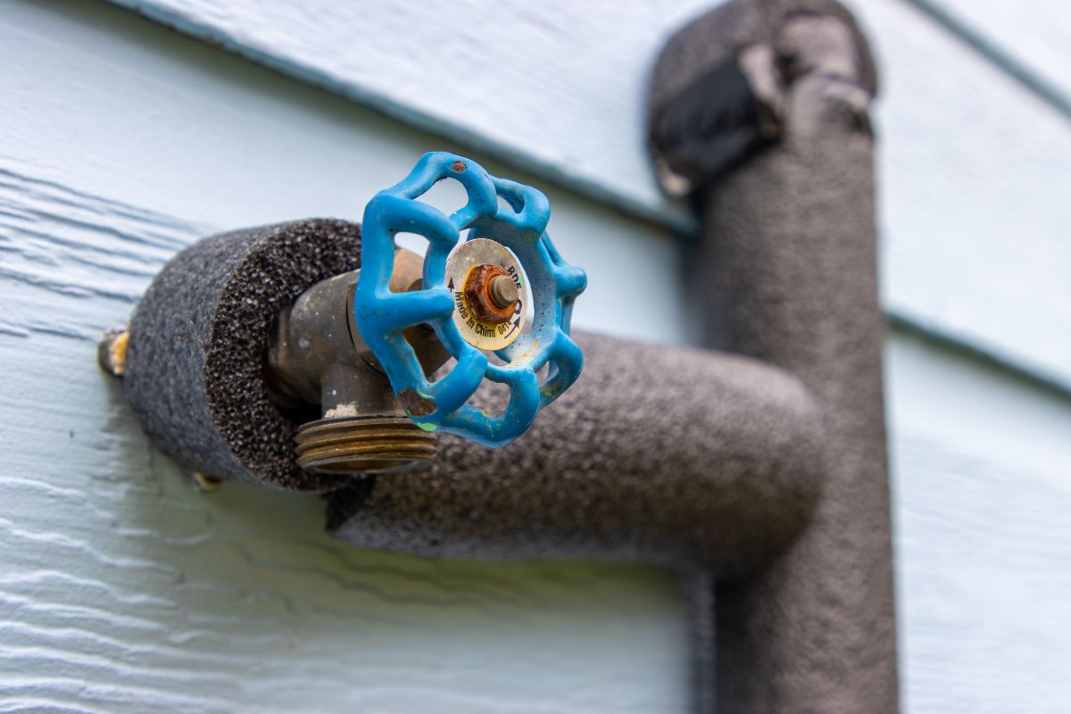 Outdoor faucet insulated with foam to prevent frozen pipes during winter in Austin and Hutto homes